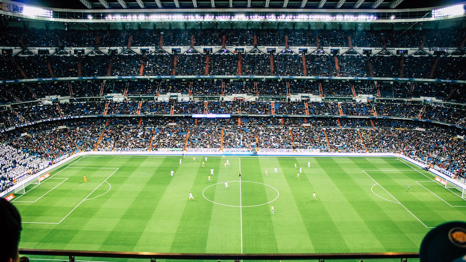 Floodlit football stadium at night on transfer deadline day
