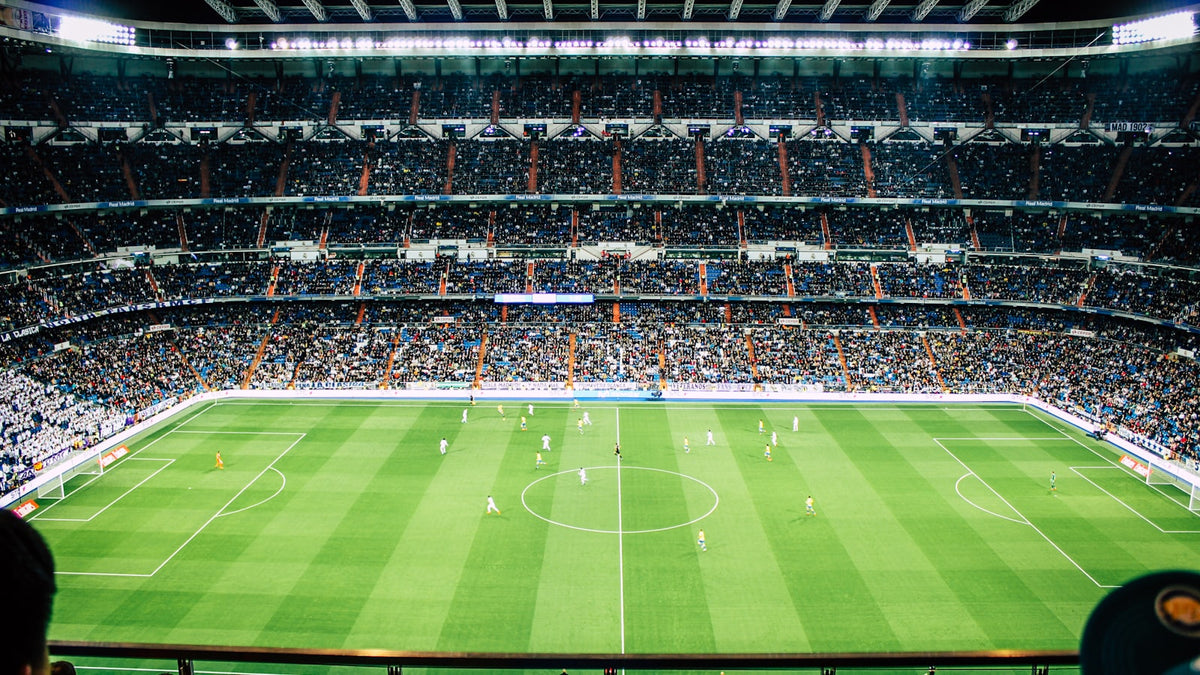 Floodlit football stadium at night on transfer deadline day