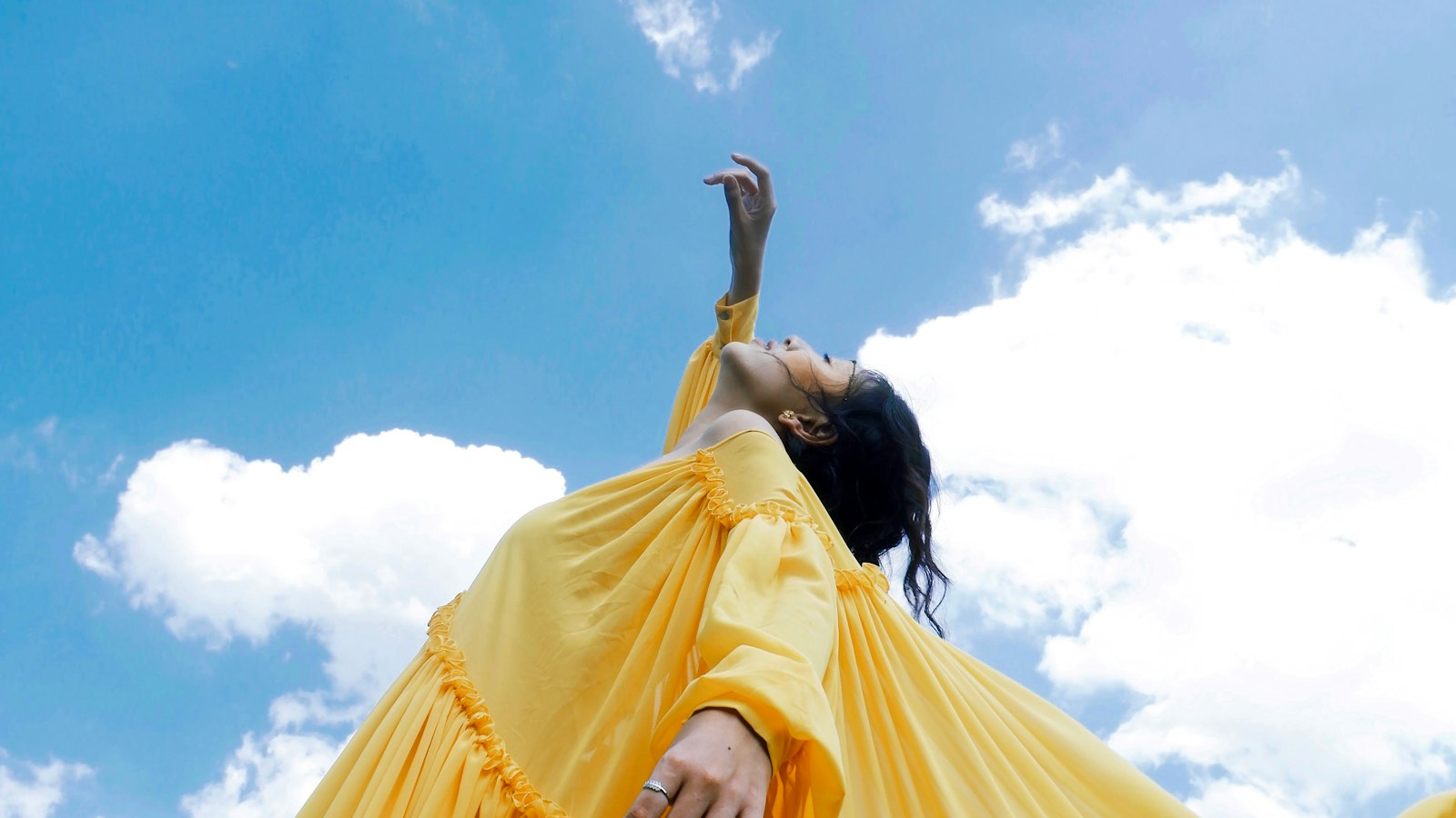 Model in a golden dress photographed in editorial style, echoing the all-gold Saint Laurent Spring 2027 collection at Paris Fashion Week