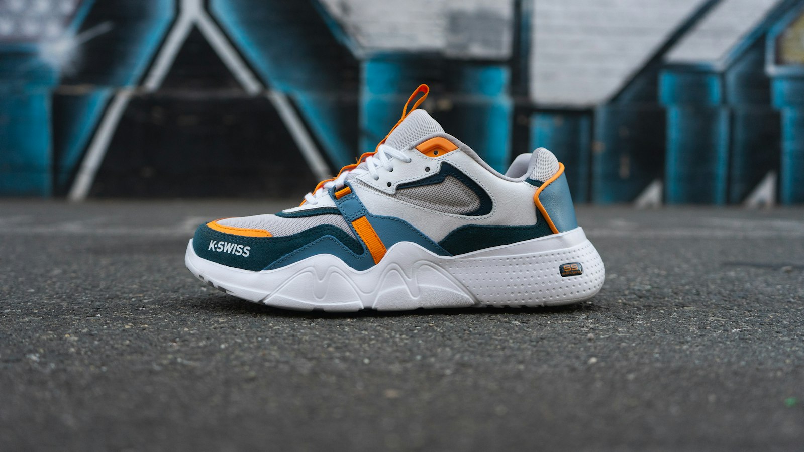 Sneakers on asphalt against graffiti, the kind of pair sneaker raffles are built around