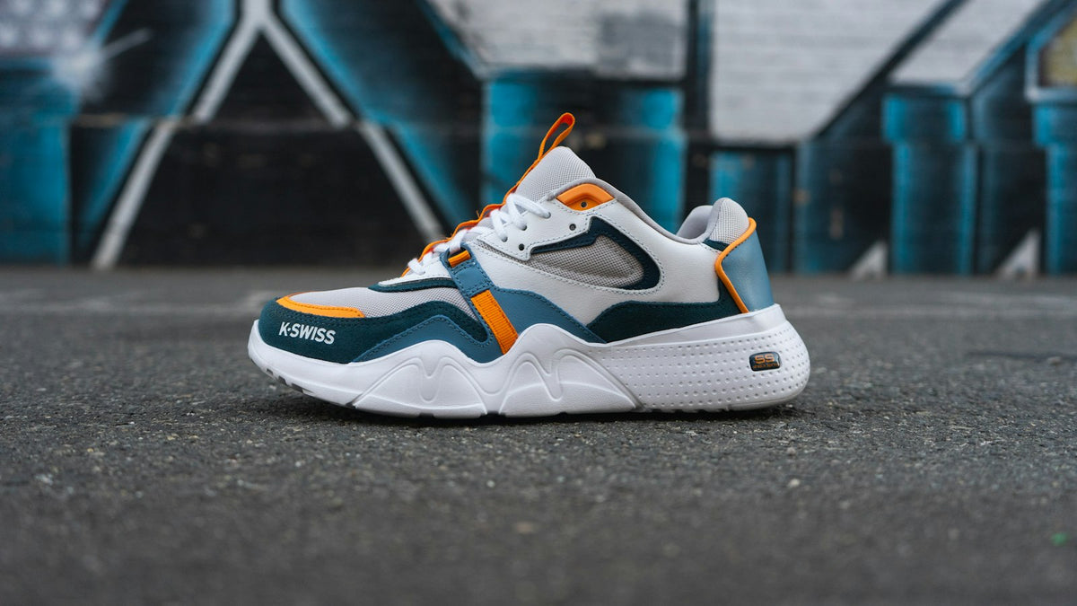 Sneakers on asphalt against graffiti, the kind of pair sneaker raffles are built around