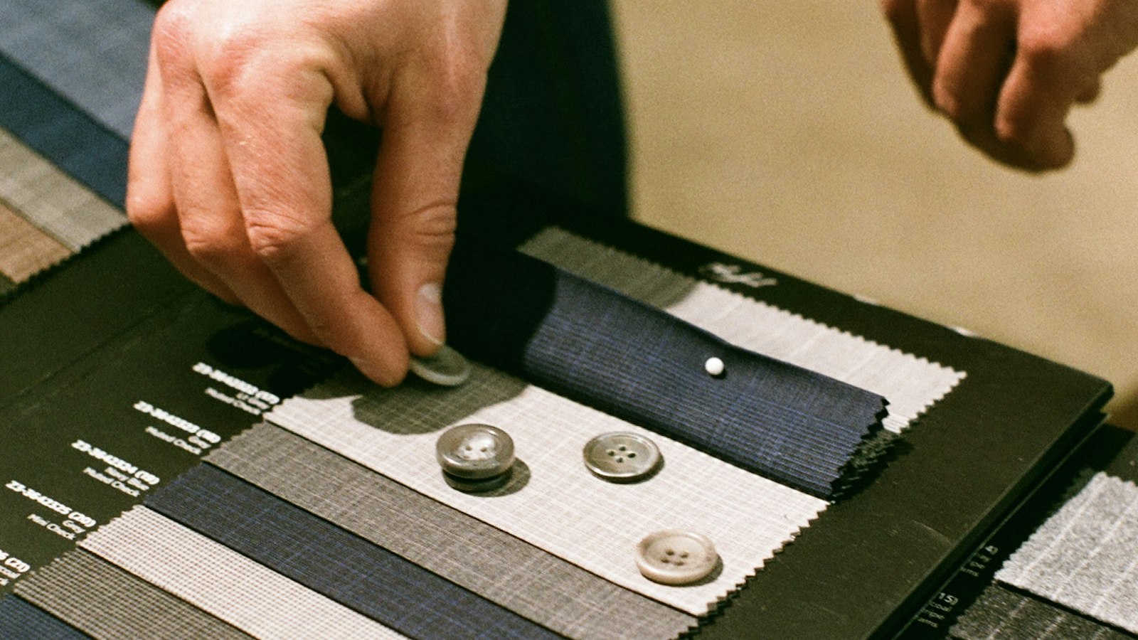 Tailor working on a garment in a moody atelier — Giorgio Armani Spring 2027 and the craft that outlives its founder