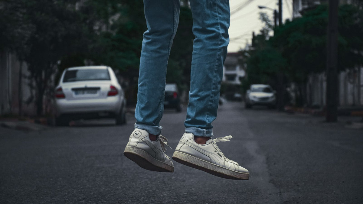 Sneakers on a city street at dusk, the kind of pairs affected as Nike cuts Jordan retro releases