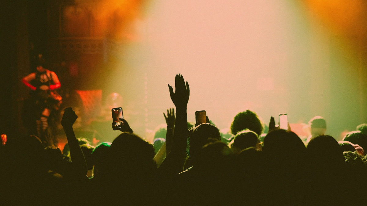 Crowd with raised hands under hazy stage lights, the energy of ComplexCon 2026 day one in Los Angeles